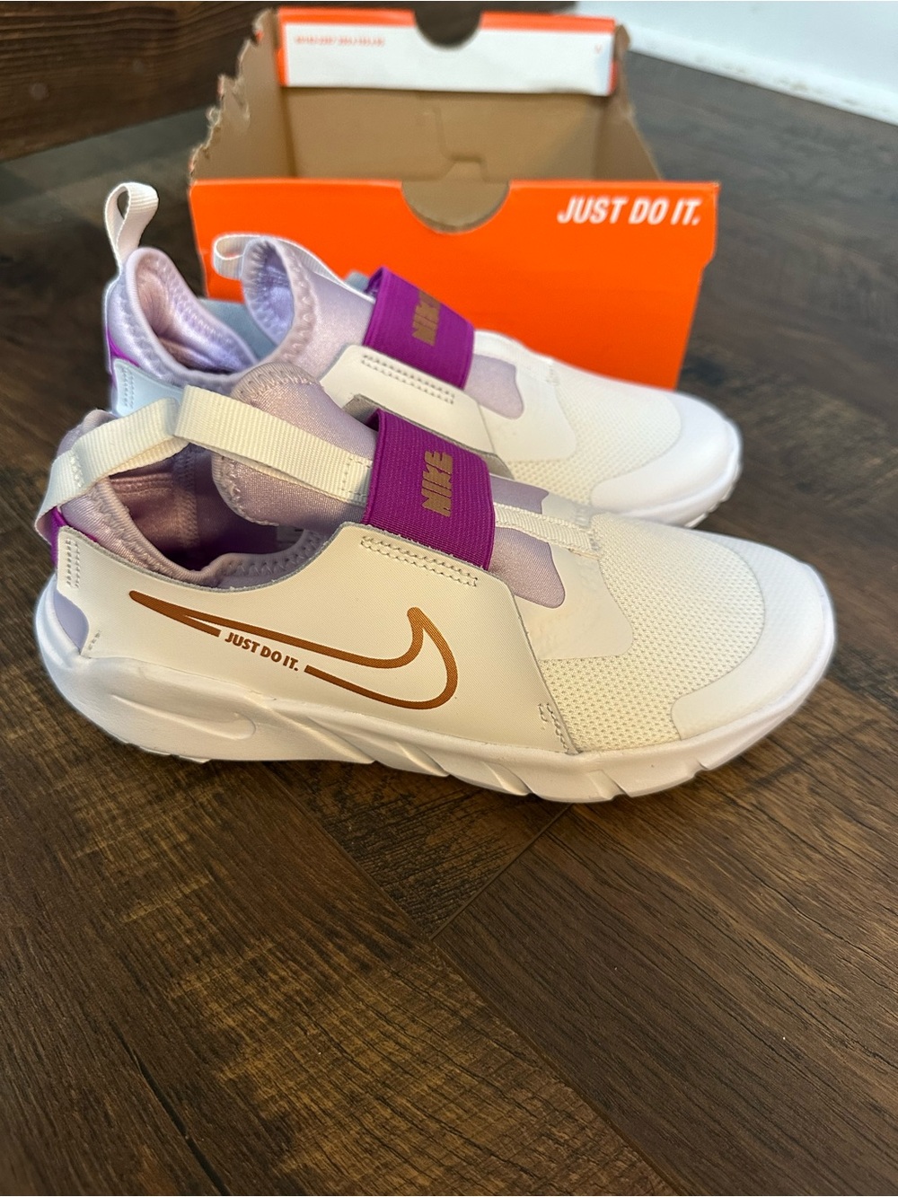 Nike Kids White Sneakers with Purple Accents and Gold Swoosh